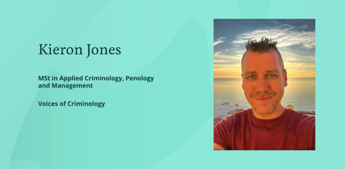 A photograph of Kieron Jones, standing in front of the seashore in the evening.