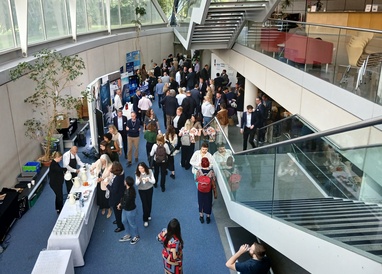 Group of delegates circulating in the foyer area outside of the lecture theatre
