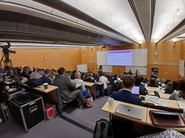 Delegates seated in lecture theatre observing the presentation