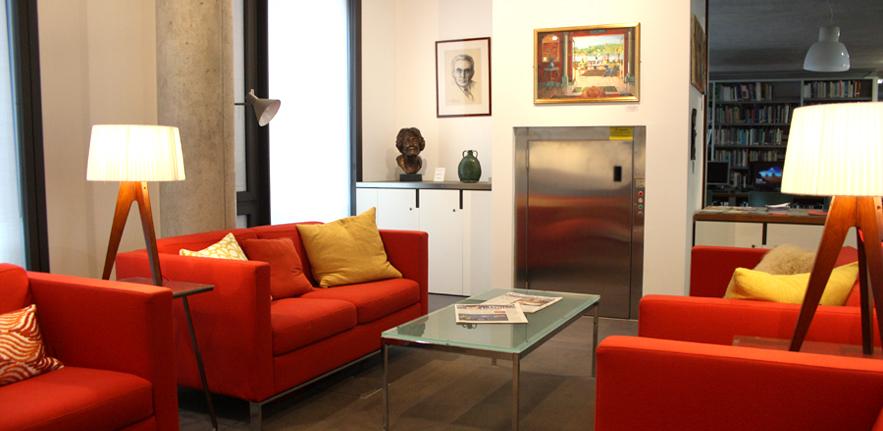 The sitting room area of the library, with comfortable seating and artworks.